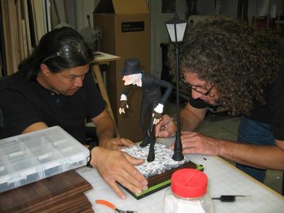 This is a 1/6th scale 3D printed Disney's Christmas Carol Scrooge statue with functioning flicker light on a stained wooden base.	