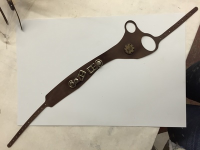 This is a leather hand and wrist band with RFID sensor we designed and created for an multi media interactive escape room.	